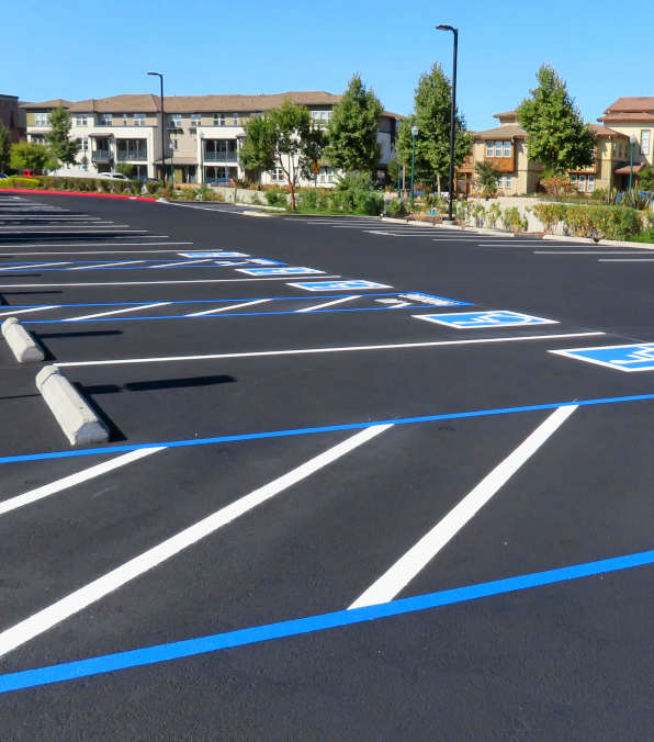 new asphalt parking lot with striping and ADA stalls